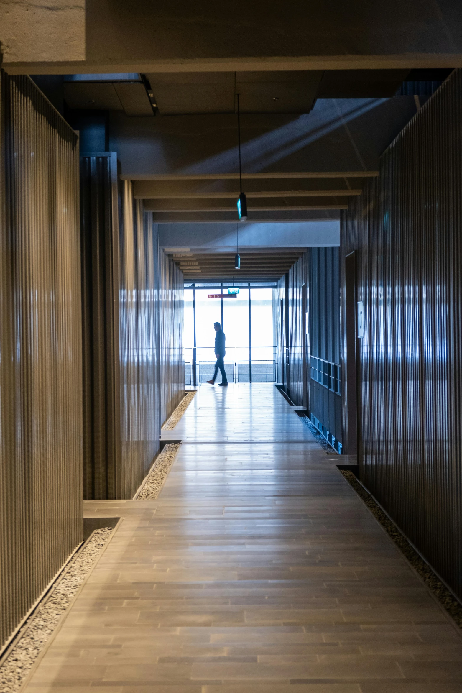 an empty hallway with wood flooring and wall coverings