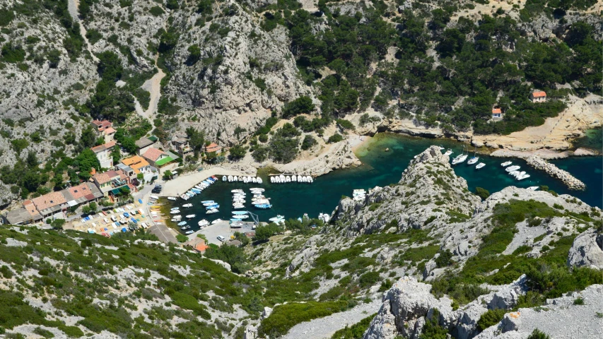 a small boat harbor in a valley with rocky cliffs