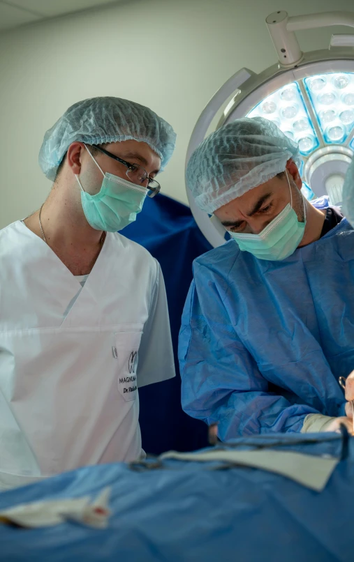 two surgeons operating on a patient in the hospital