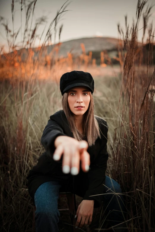 a woman that is sitting down in the grass