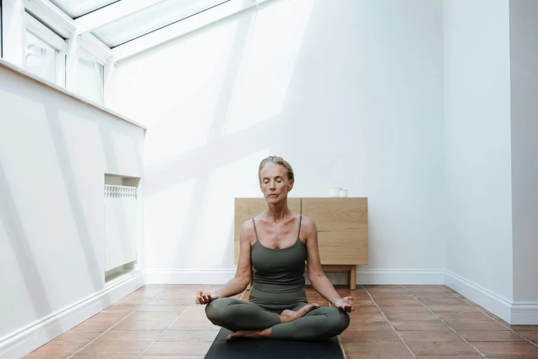 a person in a yoga pose on a yoga mat