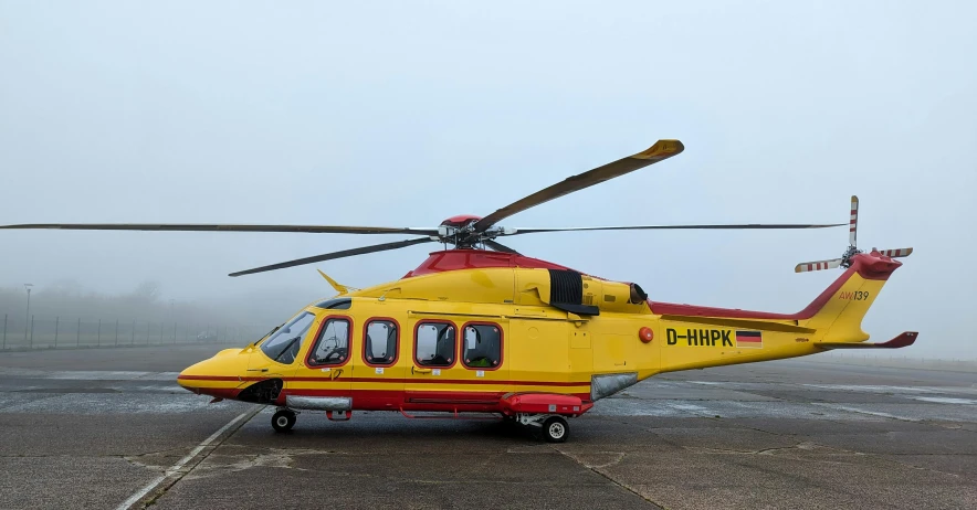 a helicopter is on a runway on a foggy day