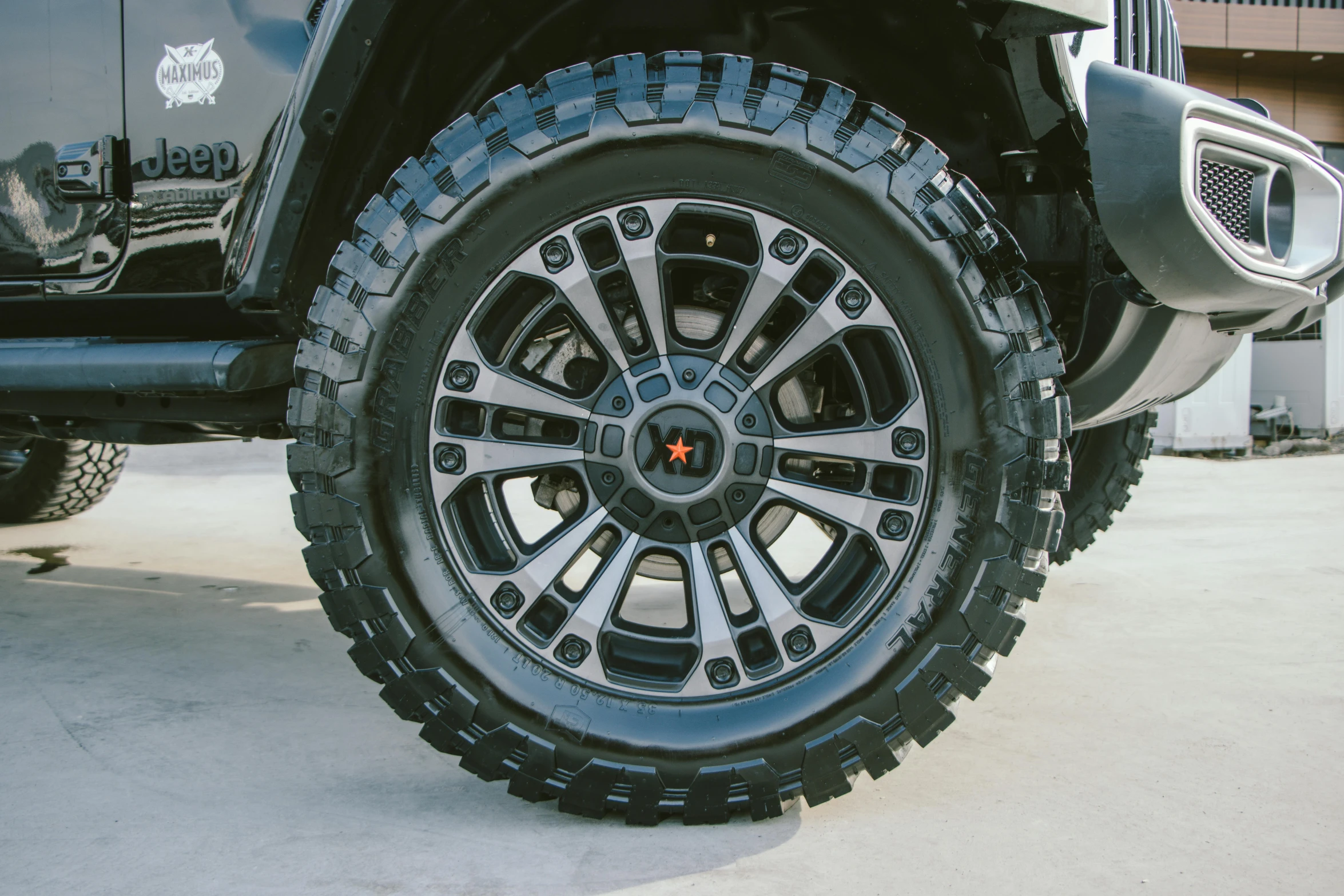 a truck tire sitting on the ground near a building