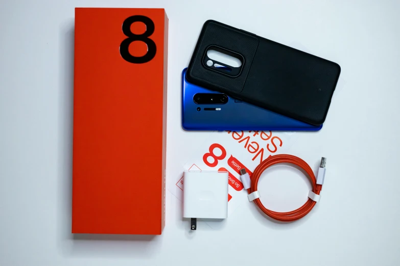 several electronics displayed on a white table with a black case