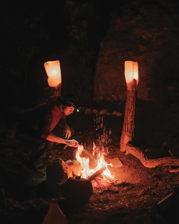 the man is making soing with some candles