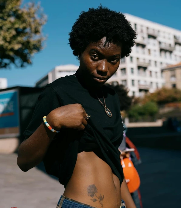 a black woman in shorts holding a cell phone