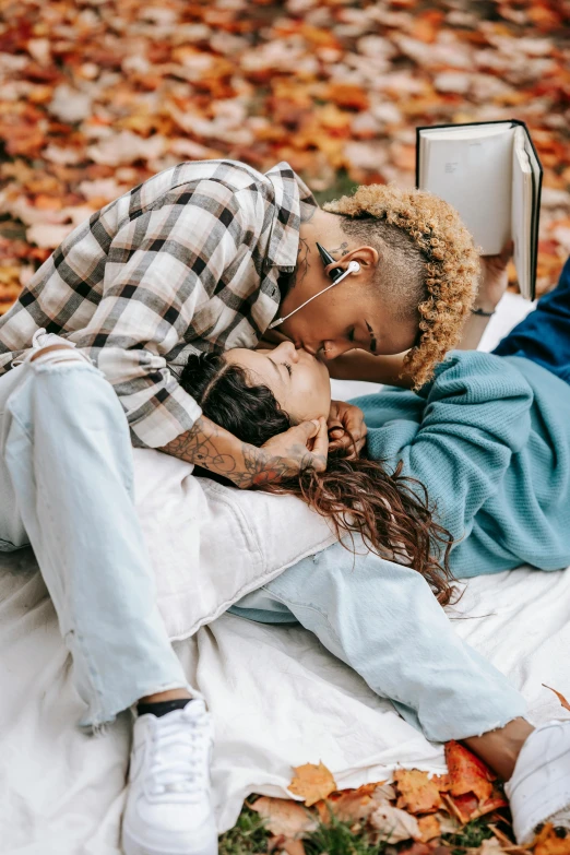 a man and a woman lying in the leaves