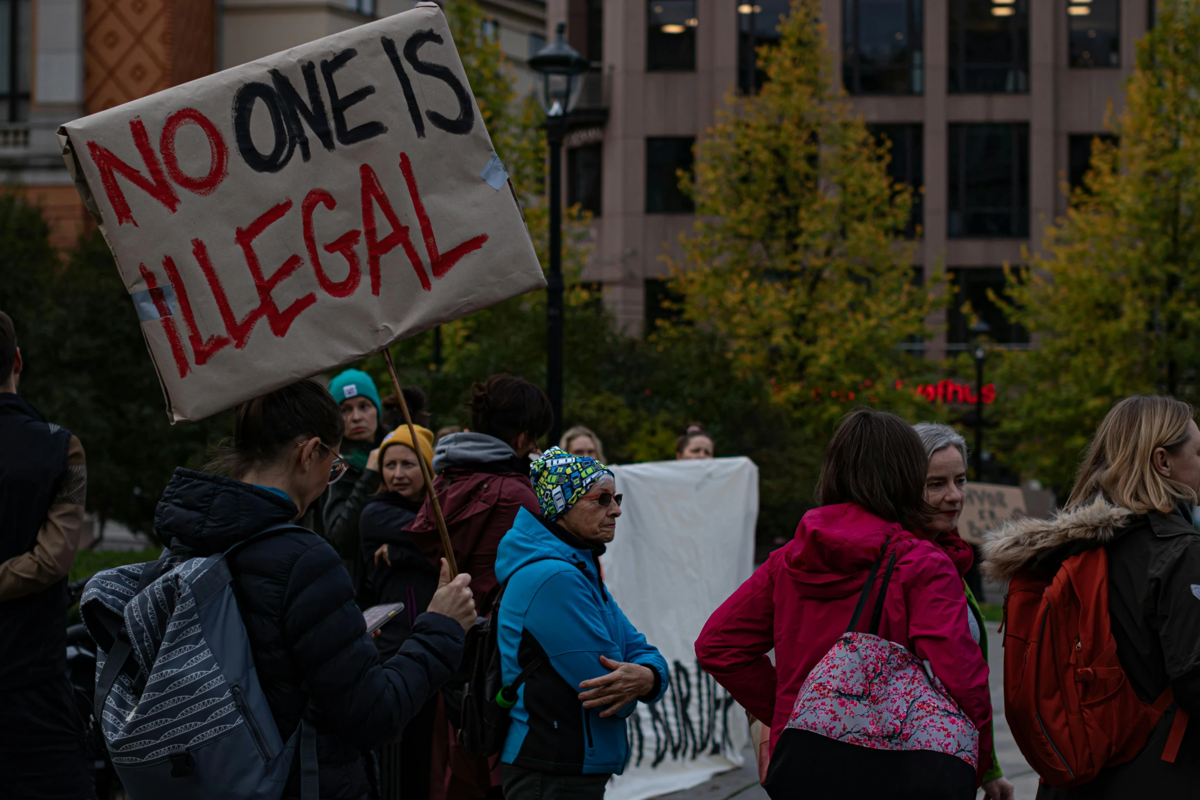 group of people with signs standing on street corner