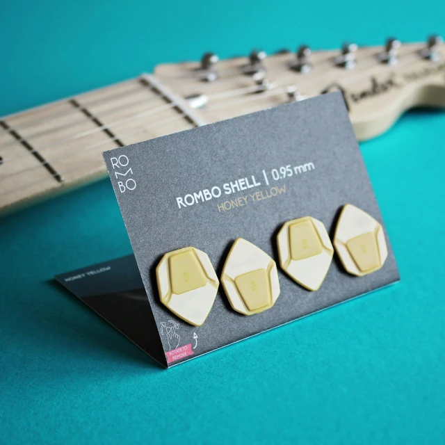 a set of three wooden studs attached to an electric guitar