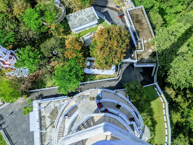 an aerial view of a building with trees around it