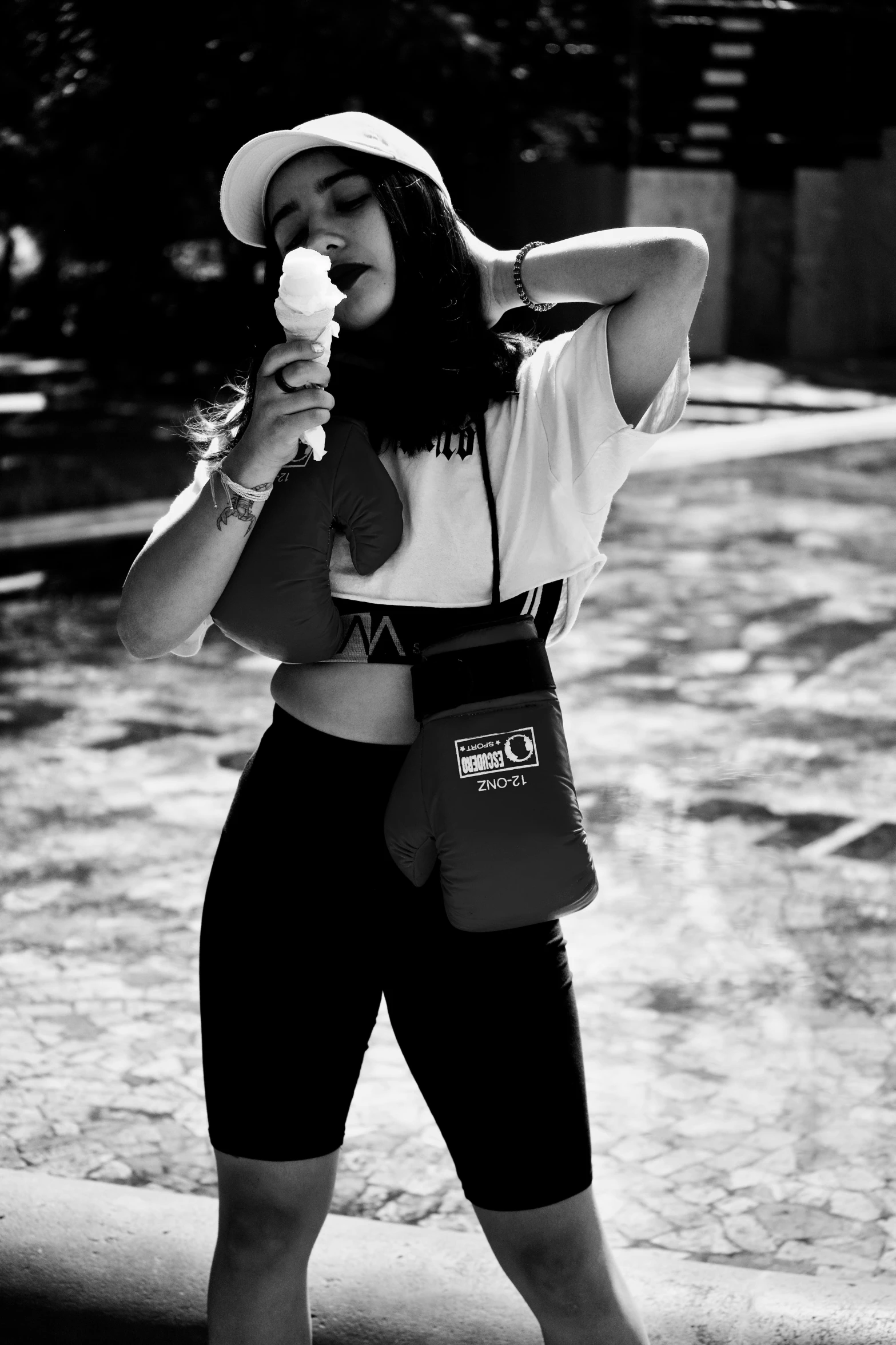 a woman in a hat eating a flower