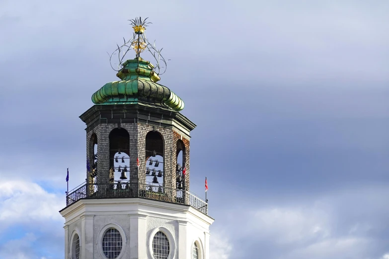 the clock tower is tall with a decorative roof