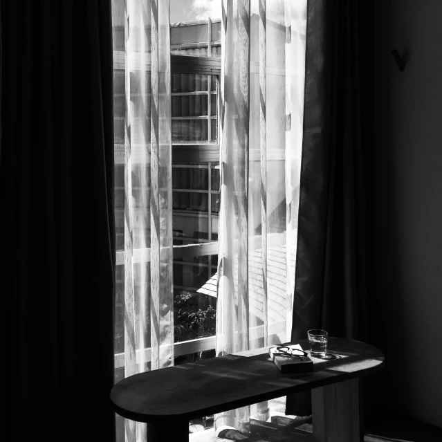 table and window in a living room with curtains