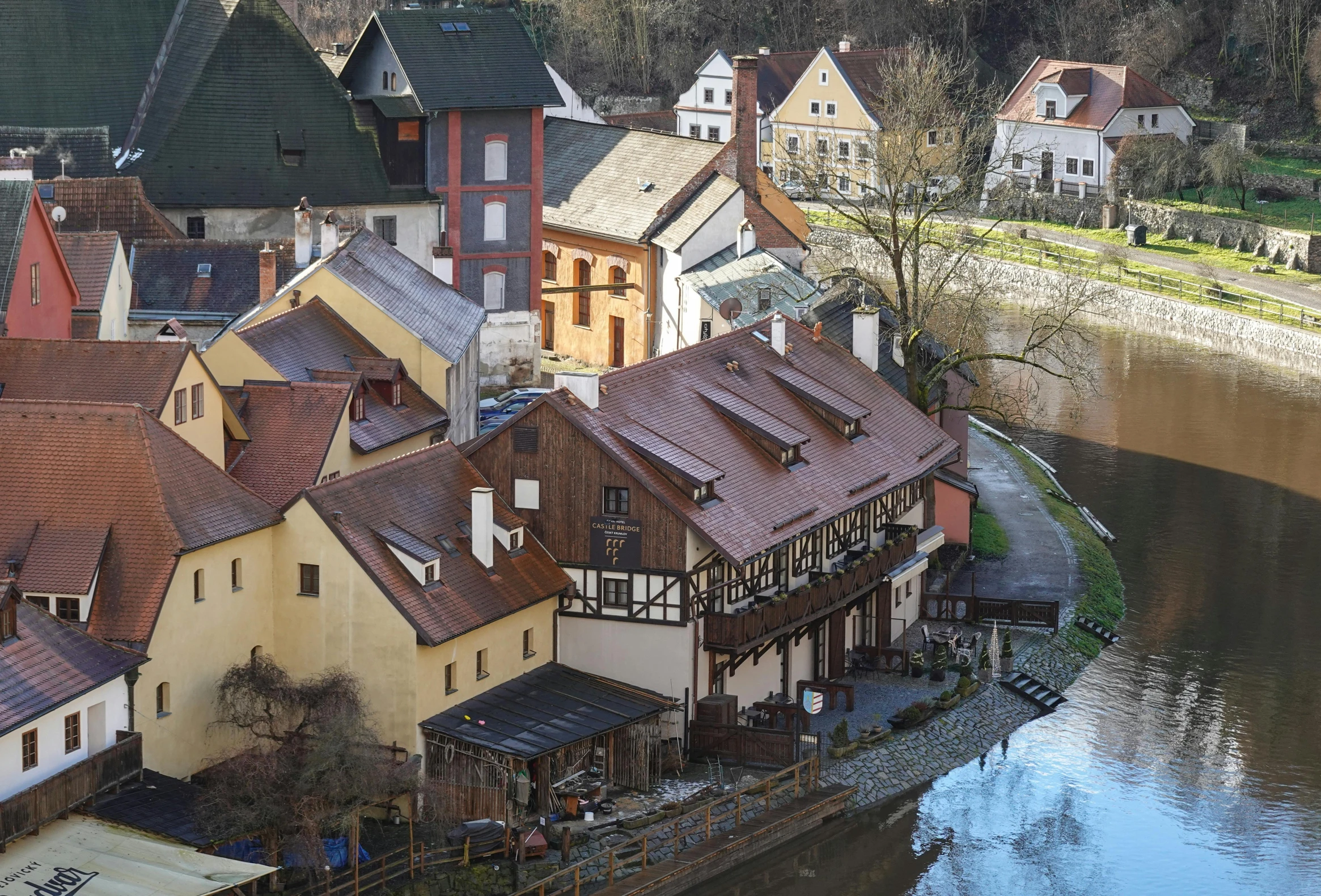 a group of buildings line the bank of a river