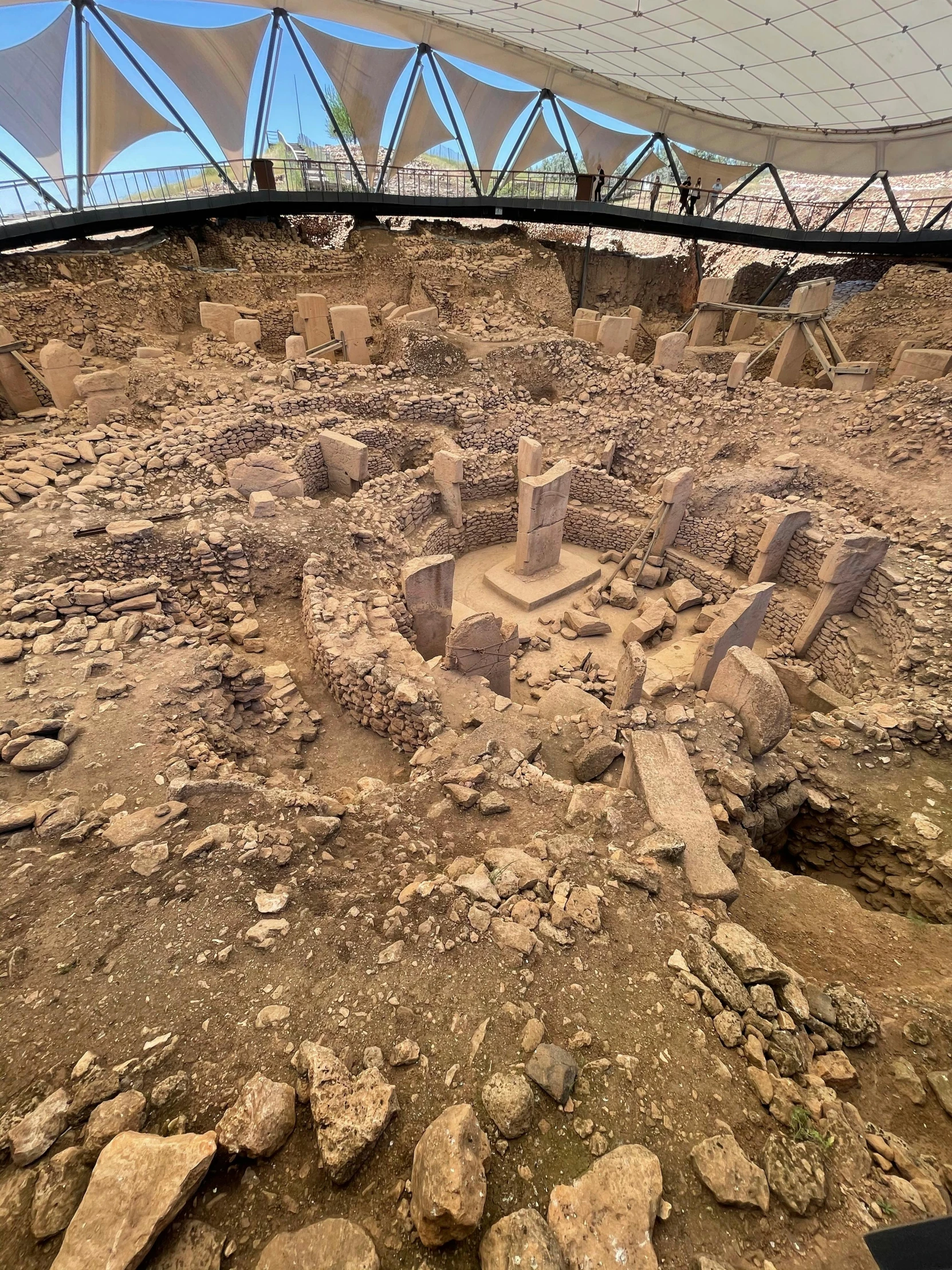 a sand model of a castle that is next to a glass