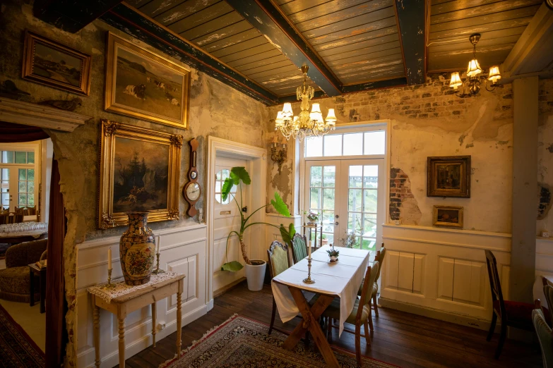 the dining room has a chandelier above the table