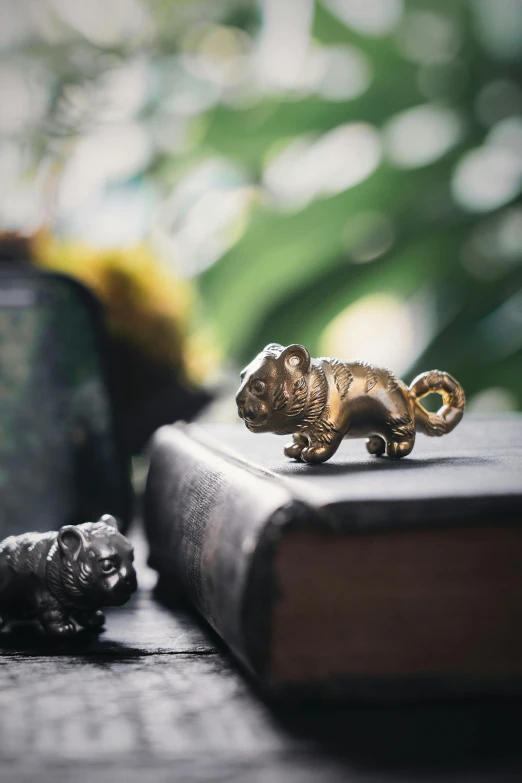 a little bronze monkey figure on top of a book