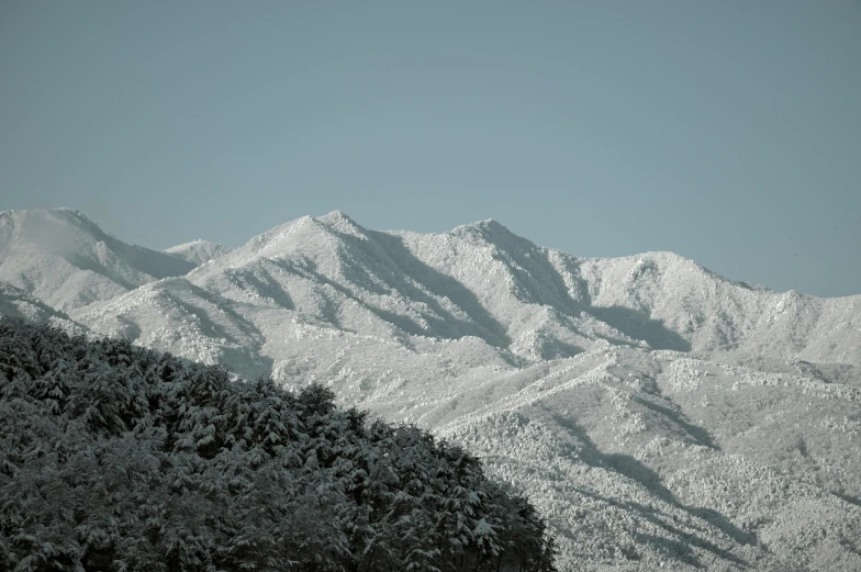 some mountains that are covered in snow and with no clouds