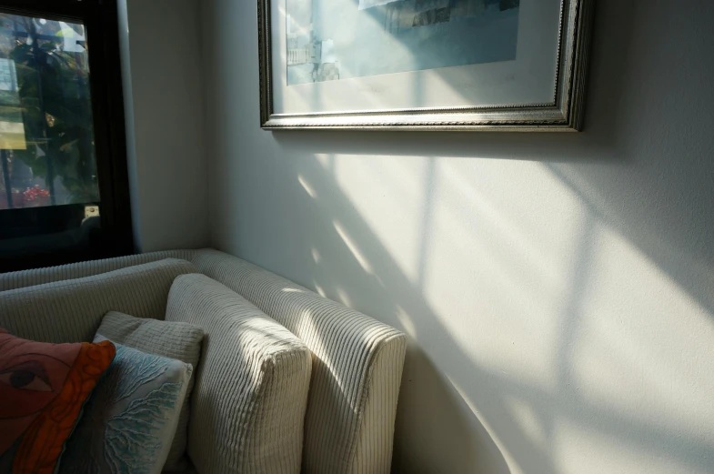 a corner of a room with a couch and some pillows