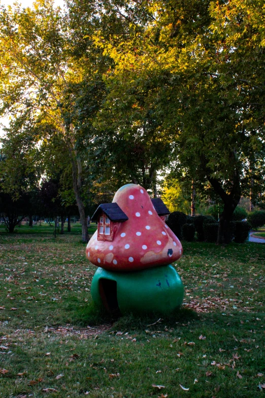 there is a large mushroom - shaped mushroom house in the middle of a lawn