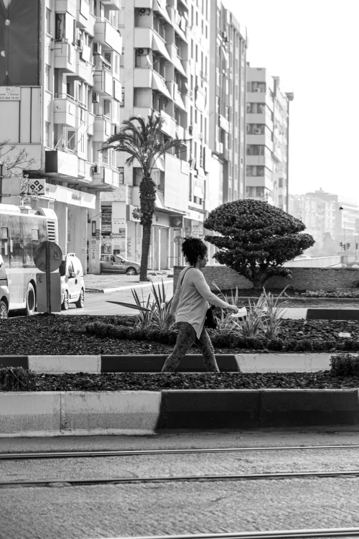 a girl walking in a park near a city