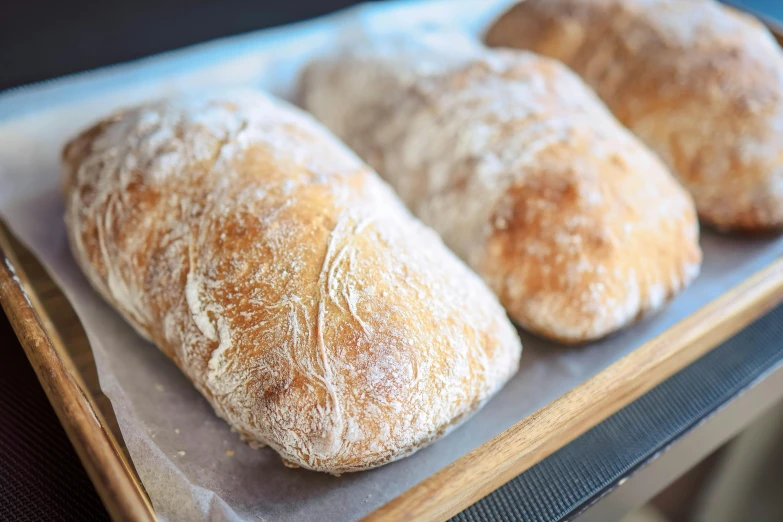 a row of bread loaves sitting on a  board