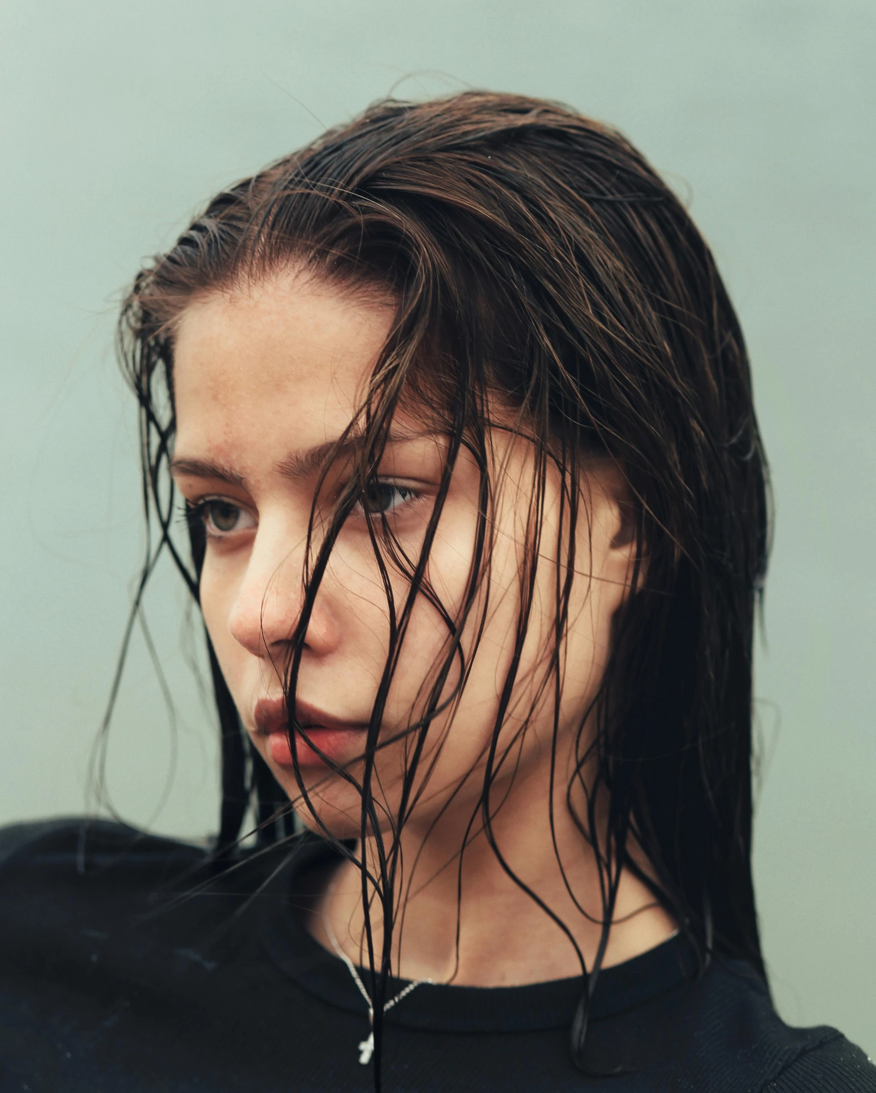 a young woman with wet hair looking at the camera