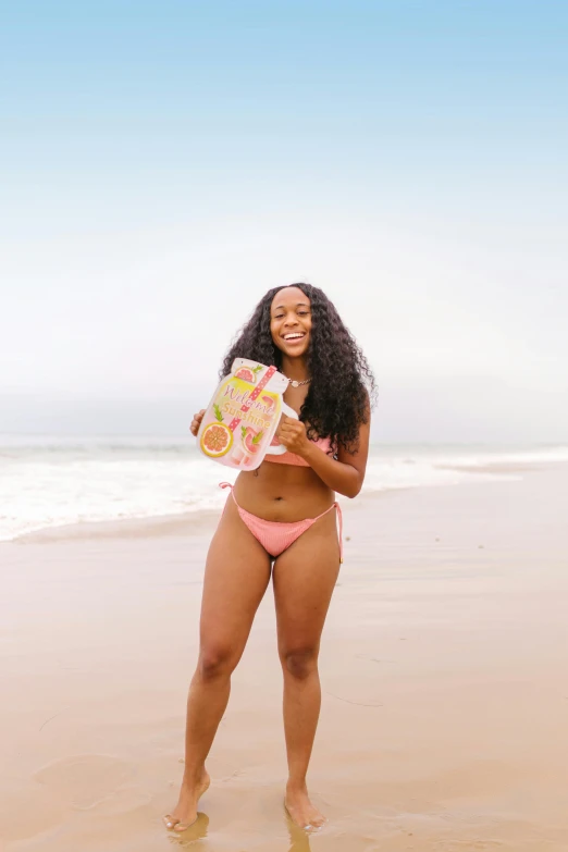 an image of a girl on the beach with a frisbee and a towel