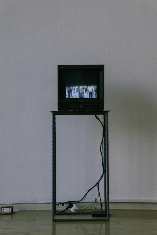 an empty television stand on the floor near a wall