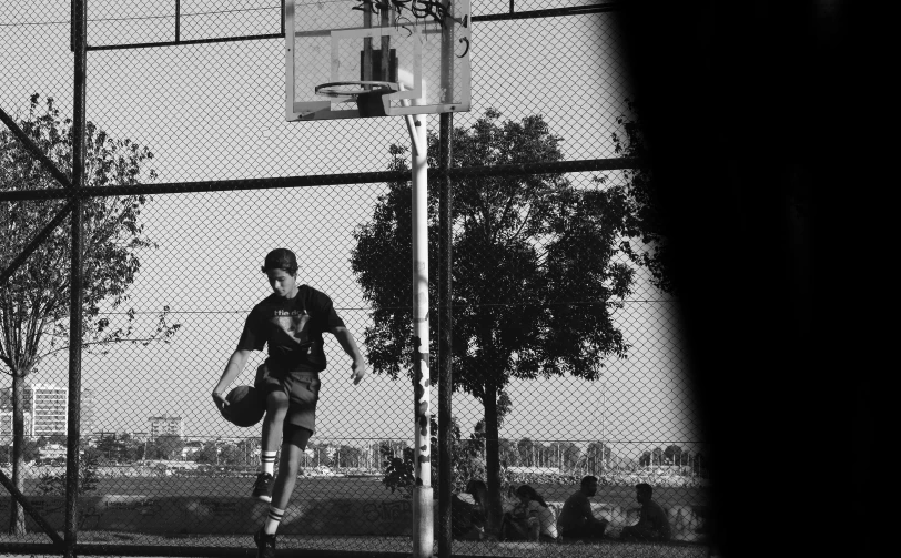 a man standing next to a basketball on a basketball court