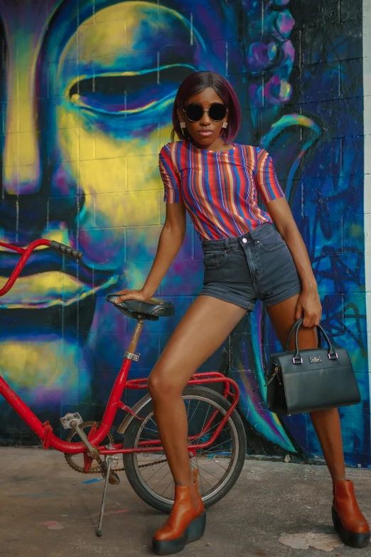 a young woman posing for a pograph beside her bike