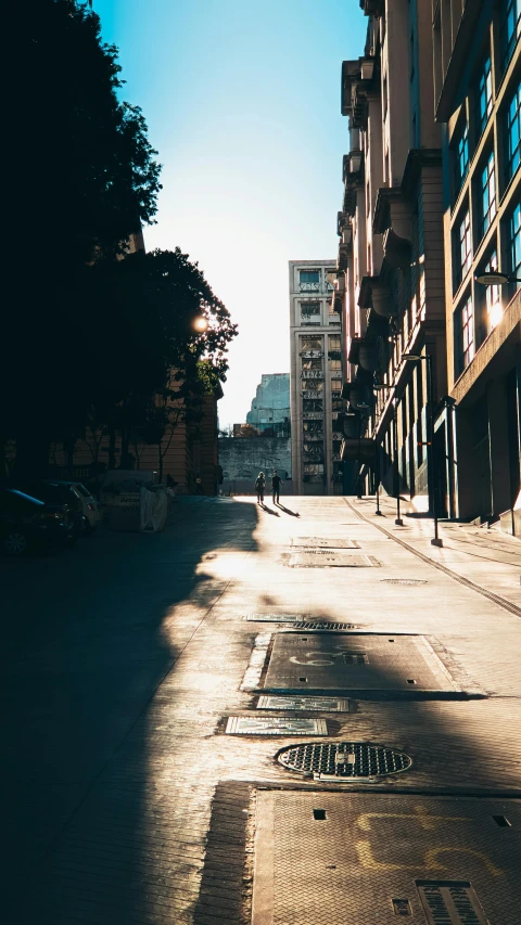 a person walks down a city street in the day