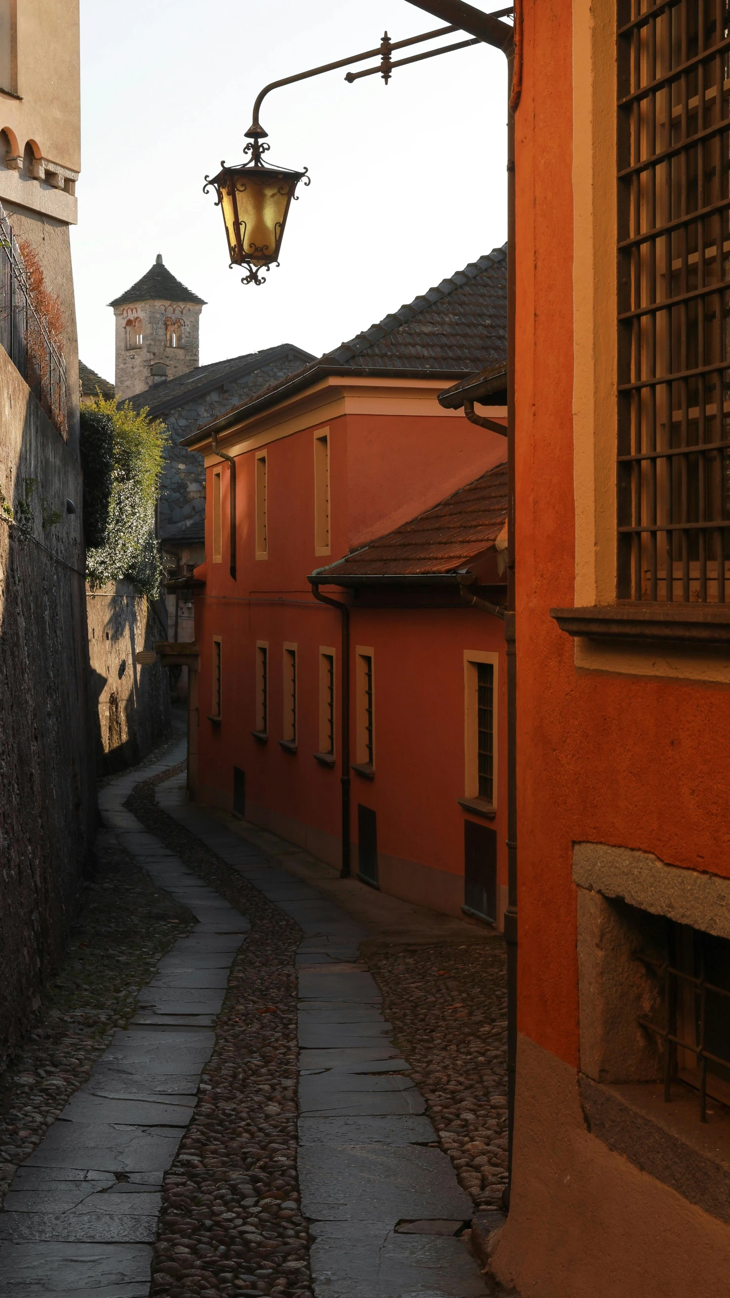 an alley way with a lamp over it