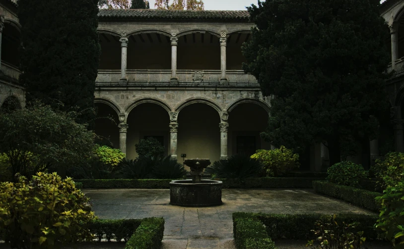 an courtyard in front of a building with several arches
