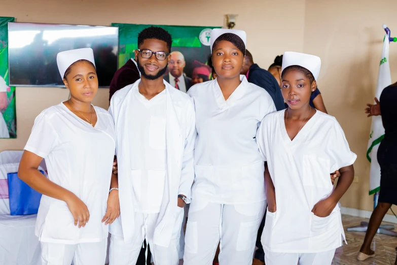 four young women wearing nurses clothing posing for a po