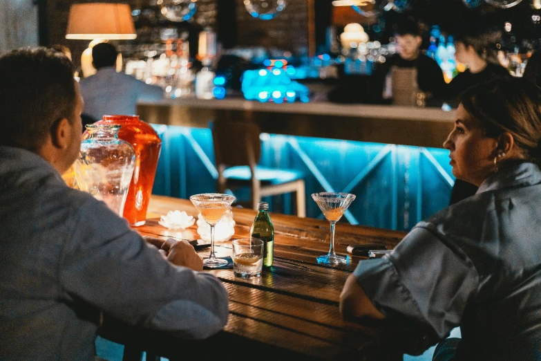 two people having drinks at a restaurant with a bar and nightlife