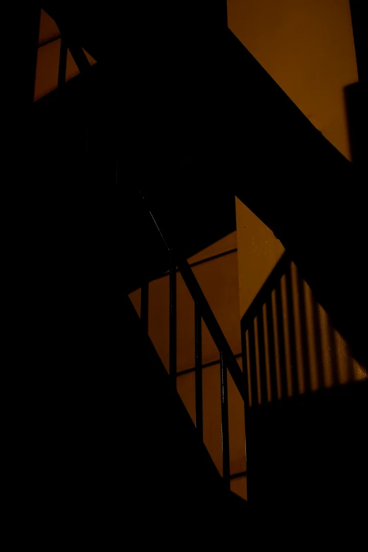 dark stair case lit by the light of a window