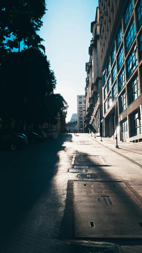 an empty sidewalk with an empty street in the background