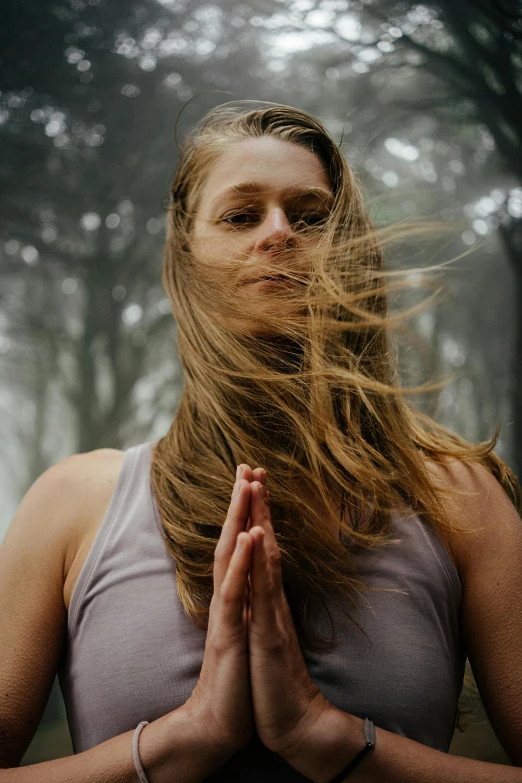 a woman with long hair in the woods