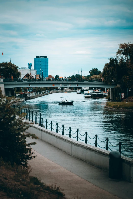 boats are in the river next to the street