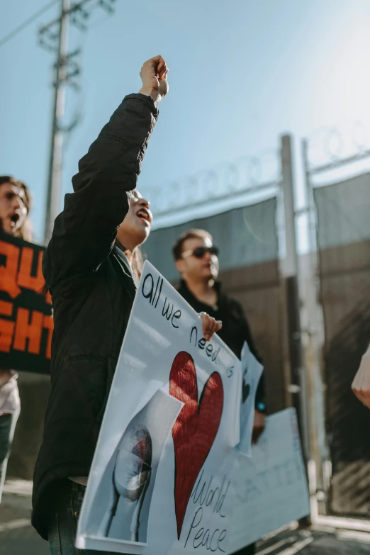 people holding a poster protesting on the street