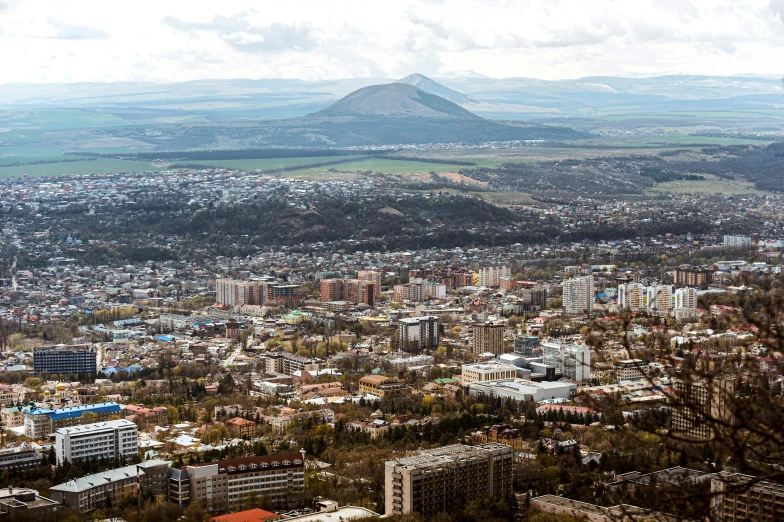 a city is shown near mountains and sky