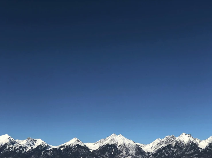 the view of the snow covered mountains and sky