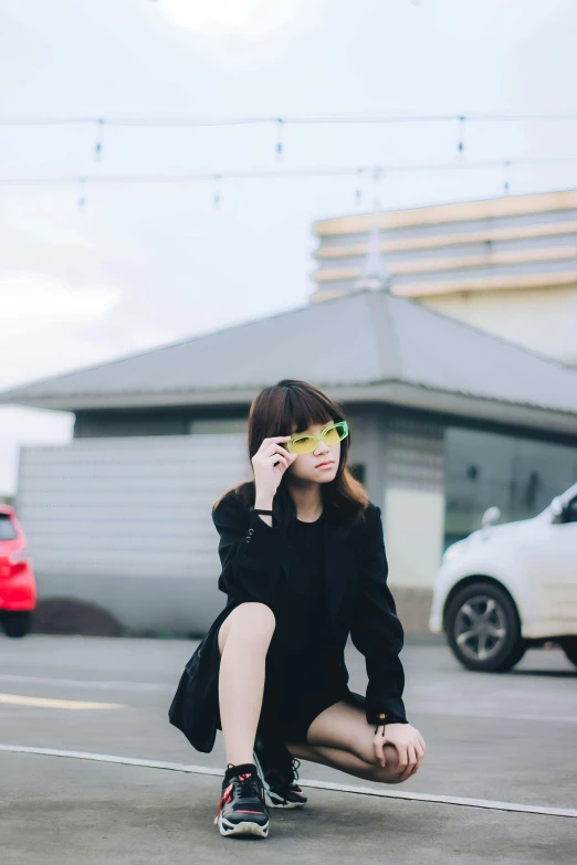 a young lady is sitting on the ground while talking on her cell phone