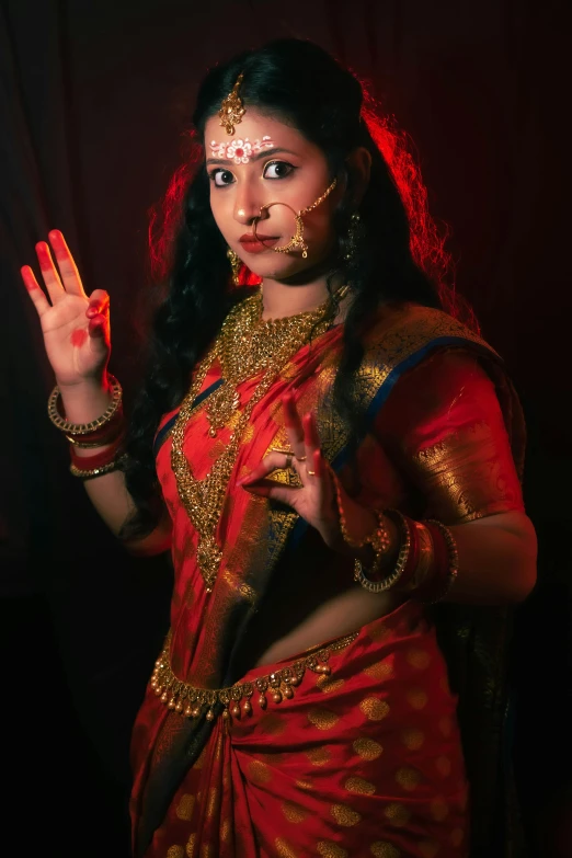 a woman is wearing a sari posing