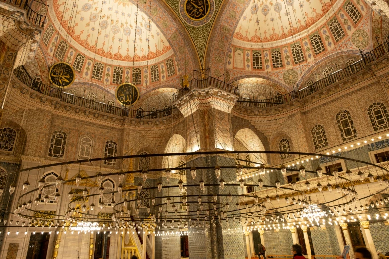 several people inside of an ornate building and lights