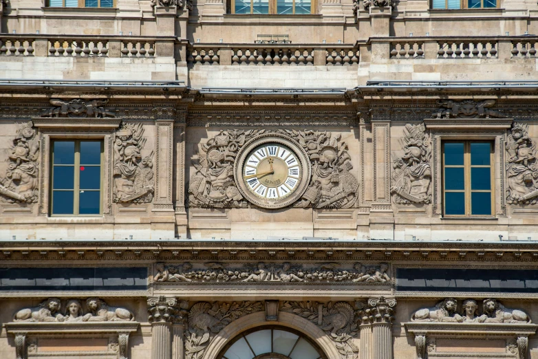 an ornate building with a clock on the front and side of it