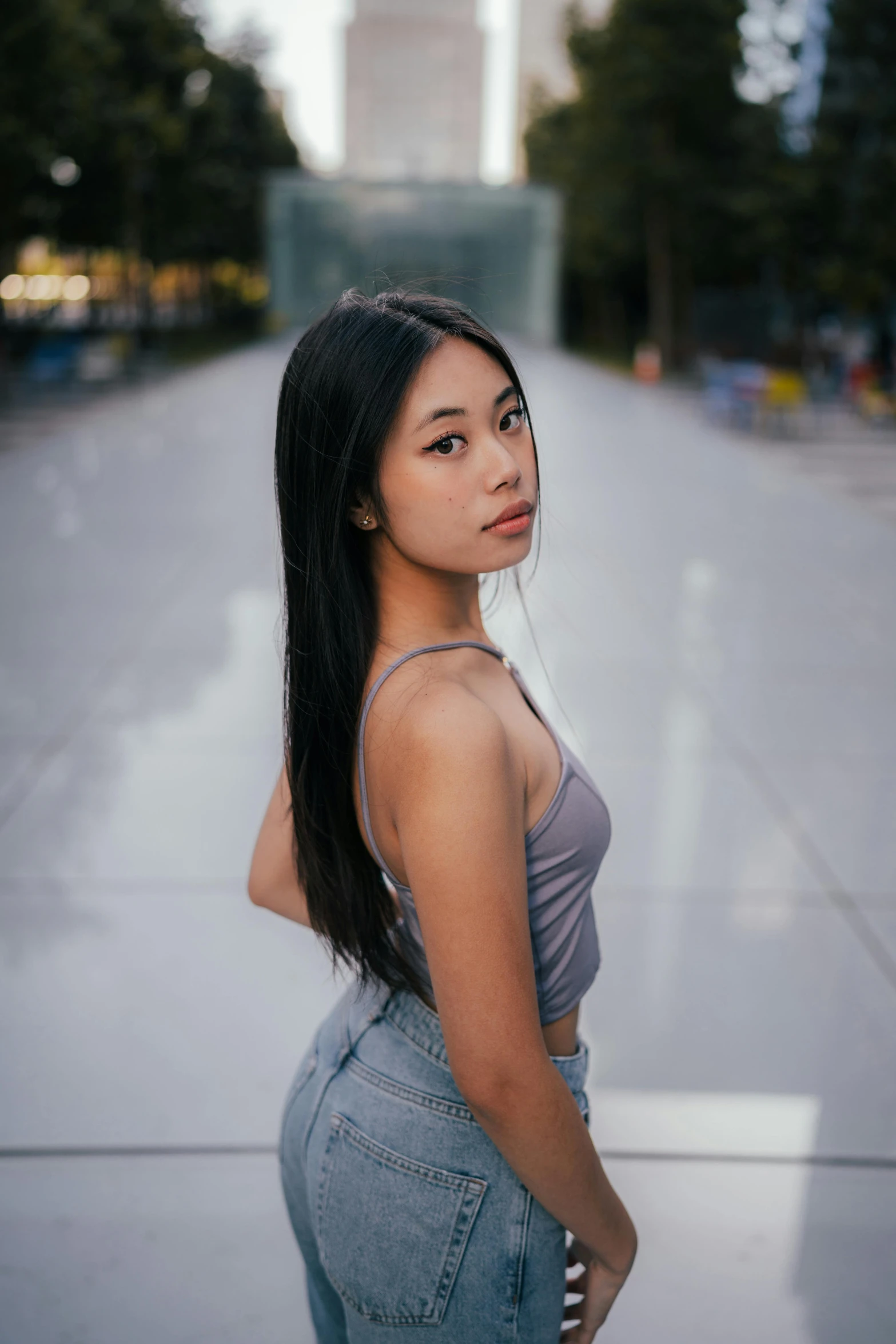 an asian girl posing on a city street