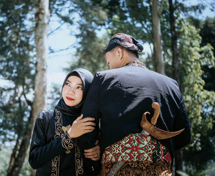 a man and woman in traditional dress emce together