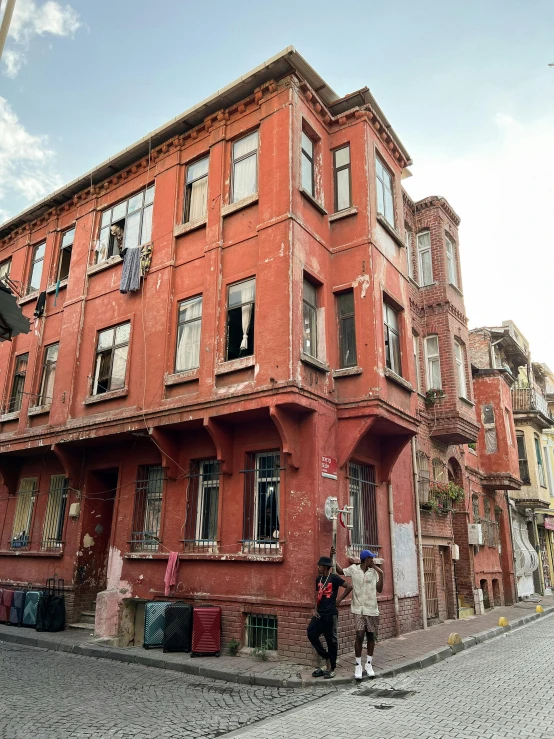 red brick building with two people standing outside